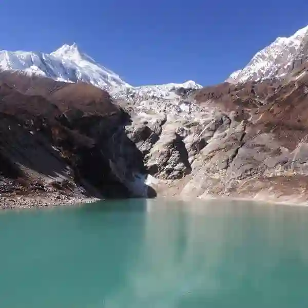 Crystal-Clear Mountain Lake Beneath Snowy Peaks