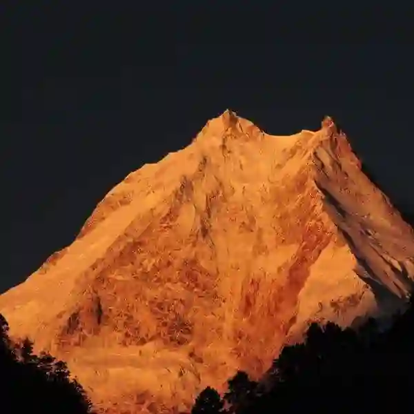 Golden Snow-Capped Mountain Peak at Sunset