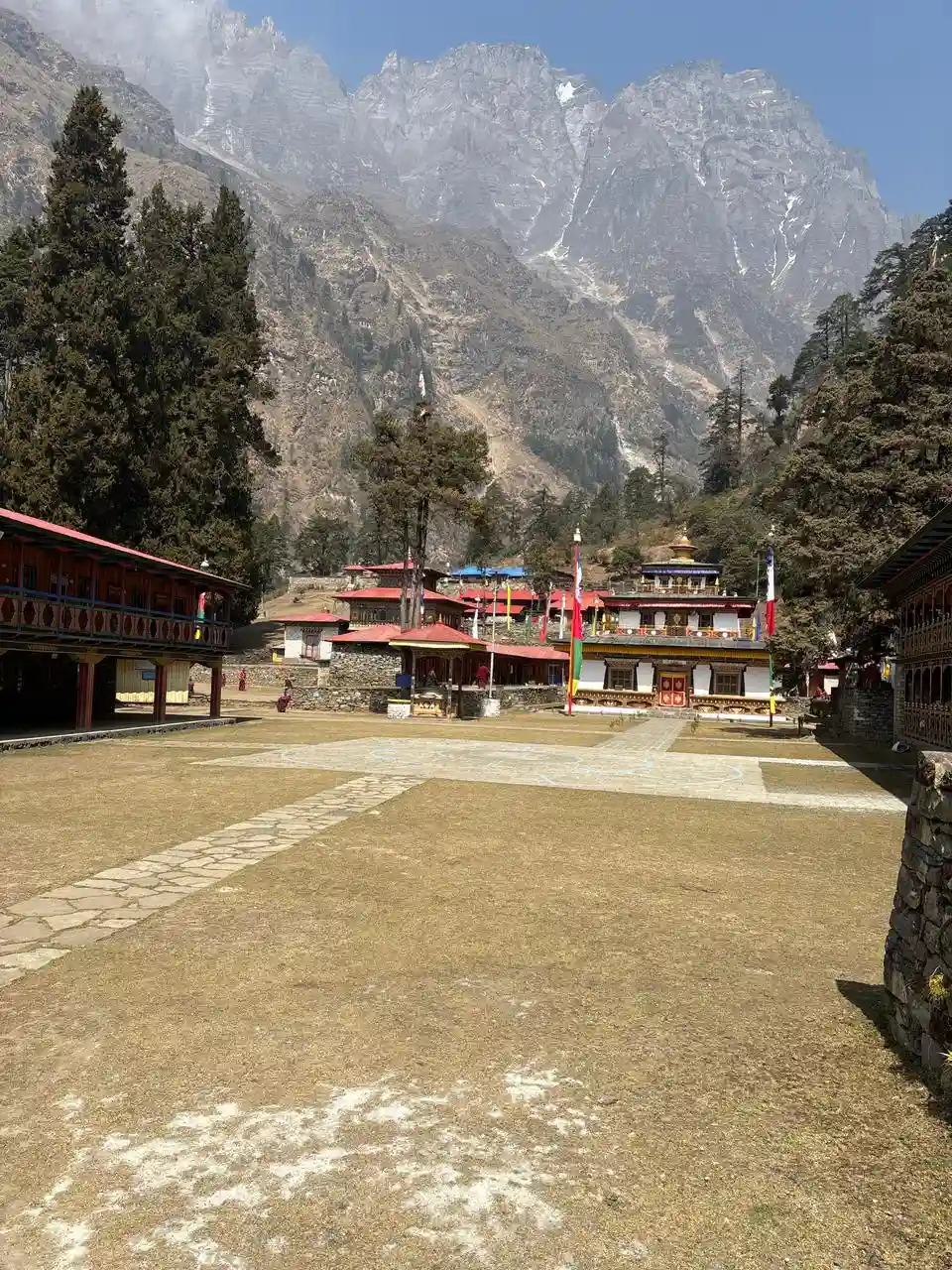 Manaslu region village with Himalayan mountains and monastery in the background